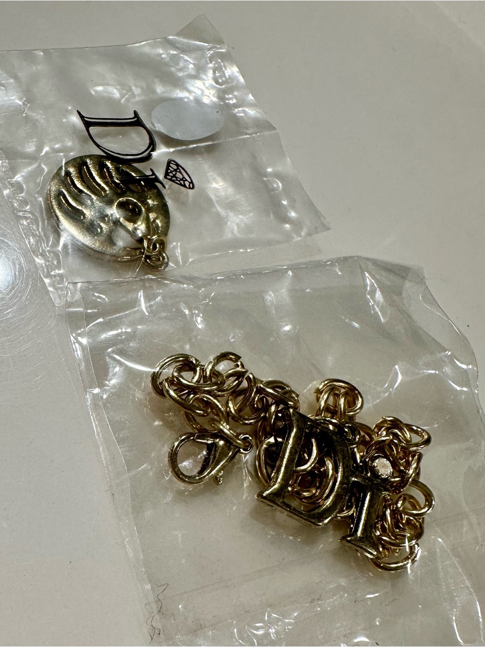 Diamonds International Gold Tone Charm Bracelet with 'D' Lettering and Bear Claw